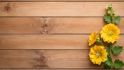 Fototapeta premium A wooden surface with a floral arrangement of yellow flowers and green leaves.