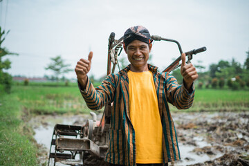 A joyful farmer celebrates amidst a vibrant and lush rice paddy filled with life