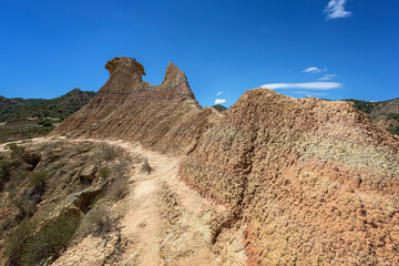 Eroded rock and mud formations in the Los Monegros desert, Huesca under an intense blue sky
