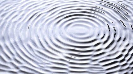 Fototapeta premium Water drop creating concentric ripples on calm surface