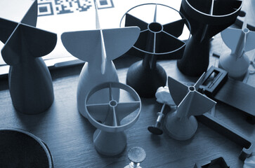 Prototype model of rocket bomb tip printed on 3D printer. Small models of tail fins, tail cone...