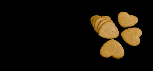 heart-shaped gingersnaps on black background