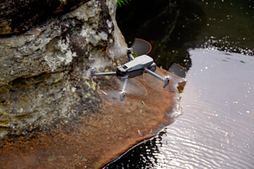 drone flying over natural waterhole, hobby recreation activity, national park sightsee photography videography