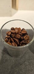 Glass of Roasted Coffee Beans on a Table