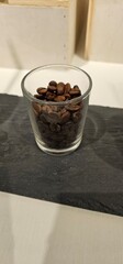 Glass of Roasted Coffee Beans on a Table