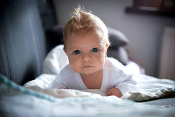 newborn baby in sleepsuits on a blanket