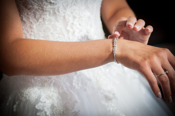 The bride is wearing a bracelet on her arm