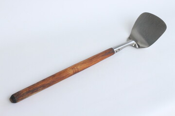 Stainless steel kitchen wok spatula isolated on white background.