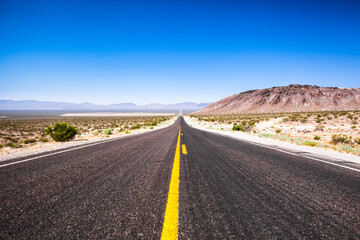 Empty scenic road in a Death Valley National Park , Nevada , USA