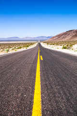 Empty scenic road in a Death Valley National Park , Nevada , USA
