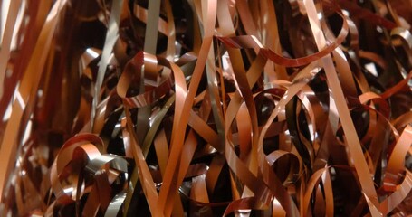 Magnetic tape unwound, magnetic audio cassette tangle, evoking nostalgia and the fragility of analog media