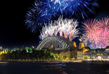 Sydney Harbour Bridge New Years Eve fireworks, colourful NYE fire works lighting the night skies with vivid multi colours NSW Australia. 