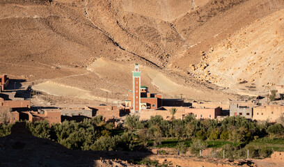 Mosque in small village in Atlas Mountains in Morocco with houses in traditional vernacular...