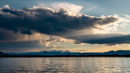 Obraz premium Dramatic sky background with dark clouds illuminated by rays of sun, intense and powerful 