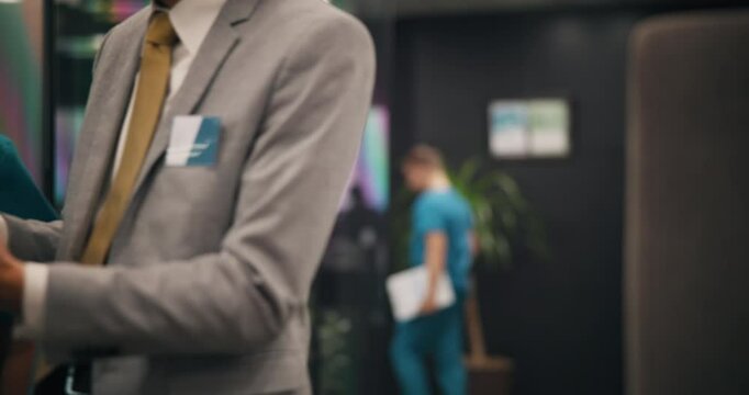 Nurse, person and walking with tablet in hospital for health management or staff service delivery. Medical administration, japanese people and digital policy to monitor performance or clinic schedule
