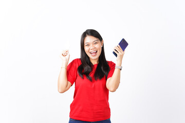 beautiful Asian woman smiles joyfully, holding a smartphone and discount voucher, thrilled about a discount