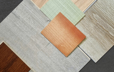 multi colors of wooden furnishing materials palette contains laminated, engineering, vinyl flooring tiles, veneer samples in close up view. wooden finishing materials palette.