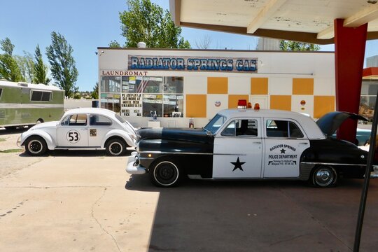 Vintage American Police Car and VW Beetle Herbie, outside Radiator Spring Gas. Seligman, Arizona, USA. June 13, 2014. 