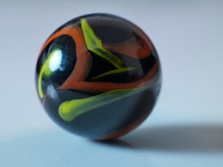 Closeup on a colorful multicolored marble on a white background
