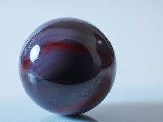 Closeup on a colorful multicolored marble on a white background
