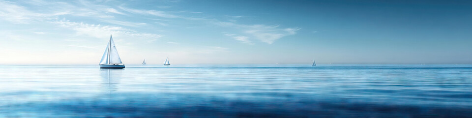 Obraz premium Seaside Serenity: A serene scene of a calm, blue ocean with white sails dotting the horizon.