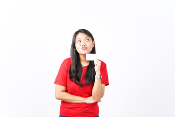 Fototapeta premium beautiful Asian woman shows happy, surprised expressions while holding blank cards for ads, set on a white background