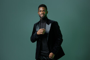 Elegant african american man in black tuxedo posing confidently for formal event or special occasion