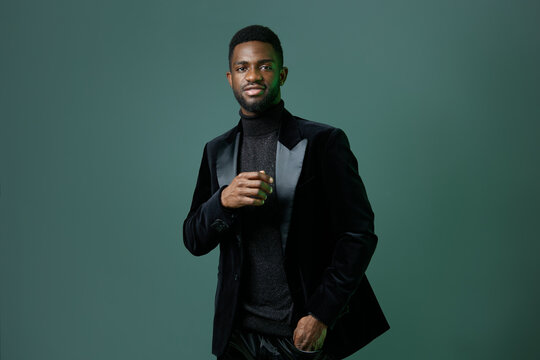 Elegant african american man in black tuxedo posing confidently for formal event or special occasion