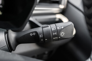 Close-up view of the car headlight switch controls.