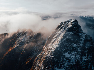 Majestic and Beautiful SnowCapped Mountain Peaks Surrounded by Dramatic Clouds Above