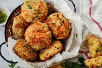Homemade cheddar biscuits topped with garlic butter and parsley