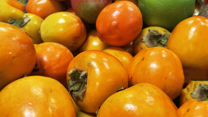 close up of ripe persimmon fruit, tropical fruit, organic fruit, healthy food concept, vitamins