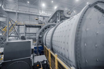 Industrial ball mill grinds ore at mining and concentrating plant. Concentration factory for...