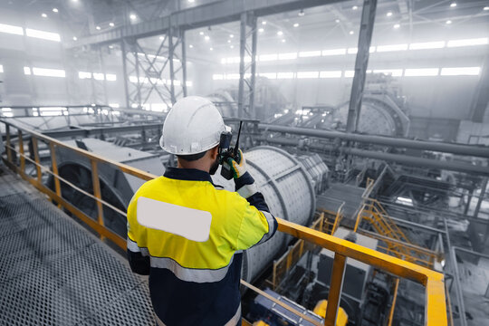 Professional heavy industry engineer worker control industrial ball mill grinds ore at mining and concentrating plant. Metal manufacture factory concentrate of copper and gold