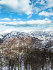 Snow-Capped Japanese Mountains Under a Bright Blue Sky

