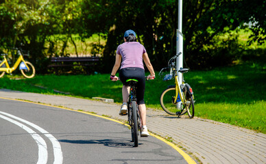 Cyclist ride on the bike path in the city Park
