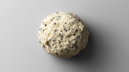 This object features a round shape with a cork-like texture, displaying a mixture of gray and black speckles. It rests on a neutral background, emphasizing its unique surface detail and color.