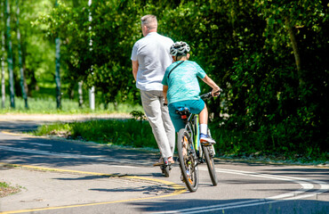 Cyclists ride on the bike path in the city Park
