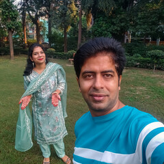 Beautiful Indian Couple dressed up as Indian tradition with henna mehndi design on her both hands...