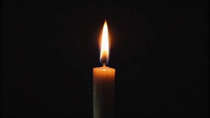 A Single Candle Flame Against a Dark Background