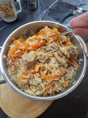 pilaf lies in a saucepan in the kitchen of a restaurant