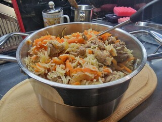 pilaf lies in a saucepan in the kitchen of a restaurant