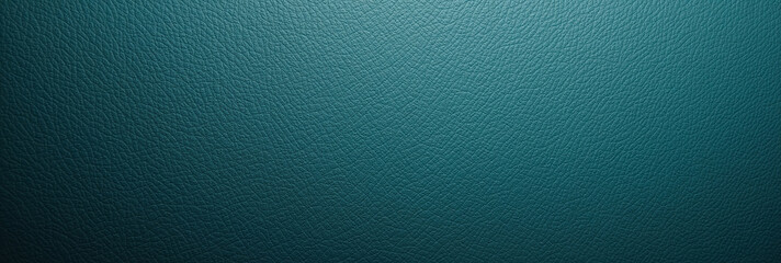 An empty, smooth teal-colored leather surface illuminated by a spotlight.