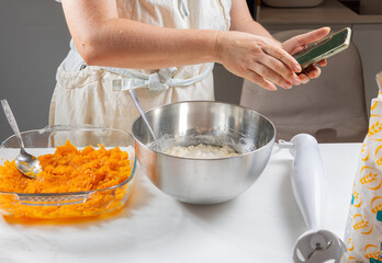 Cooking soup from pumpkin, pepper, tomato, onion, garlic using a knife and cutting board