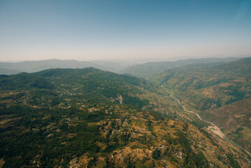 Fototapeta premium Aerial view of green and colorful rice field terraces, Nepal