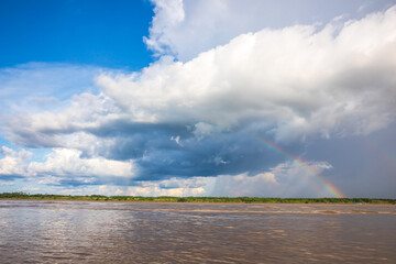 Rainbow in the amazon sky, over the great amazon river, Iquitos Peru