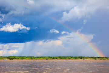 Rainbow in the amazon sky, over the great amazon river, Iquitos Peru
