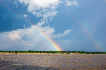 Rainbow in the amazon sky, over the great amazon river, Iquitos Peru