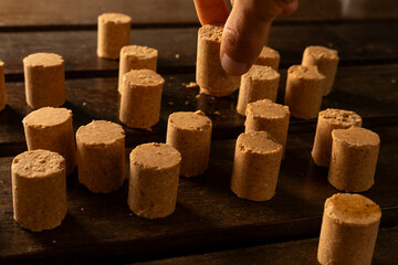 A guy's hand taking one Sweet Brazilian Peanut Called Paçoca