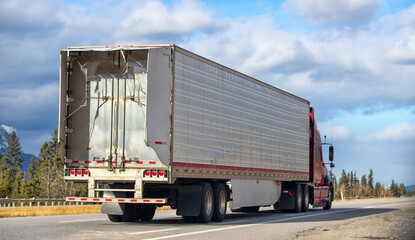 Heavy Cargo on the Road. A truck hauling freight along a highway. Taken in Alberta, Canada